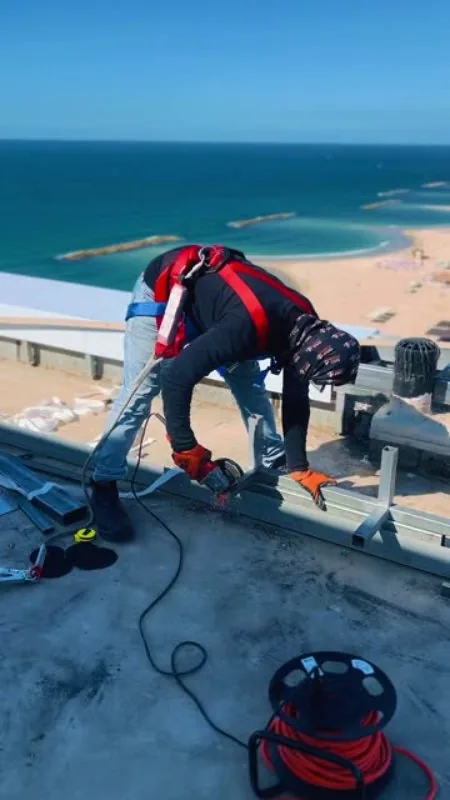 Worker on a rooftop above the Mediterranean