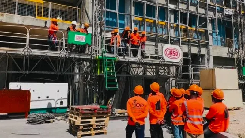 Workers in orange gear at an Israeli construction site
